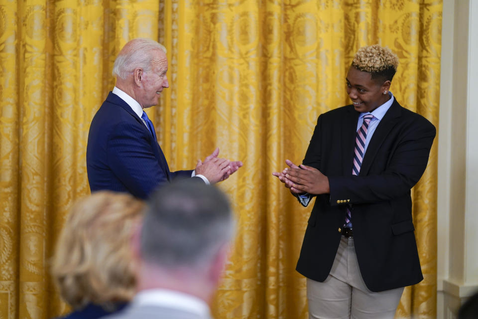 President Joe Biden applauds Ashton Mota of the GenderCool Project during an event to commemorate Pride Month, in the East Room of the White House, Friday, June 25, 2021, in Washington. (AP Photo/Evan Vucci)