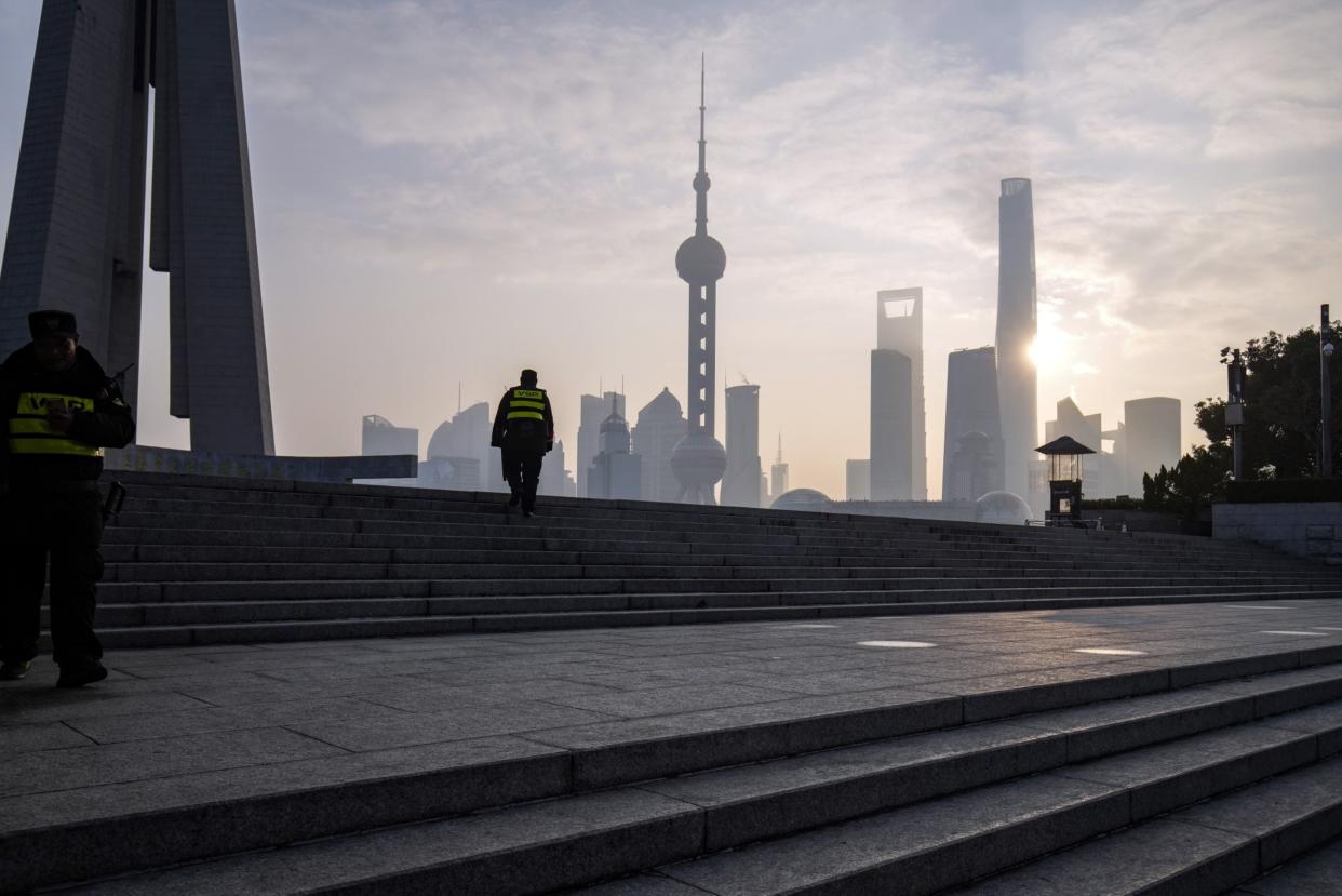 Security guards along the Bund in front of buildings in Pudong's Lujiazui Financial District in Shanghai, China, on Tuesday, Jan. 9, 2024. Photographer: Qilai Shen/Bloomberg