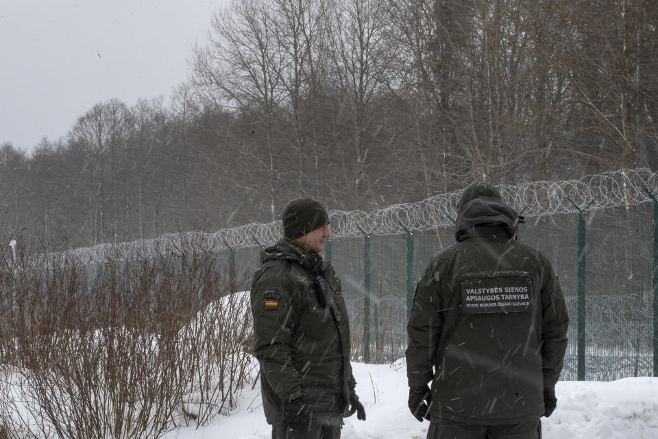 Members of the Lithuania State Border Guard Service on the border with Belarus during a visit by participants of the Conference on Border Management near the village Kurmelionys, some 40km (24 miles) east of the capital Vilnius, Lithuania, Friday, Jan. 21, 2022. The conference main objective is to discuss issues of fundamental importance in an open and informal way and to find common denominators on the issues of the protection of external borders, the response to hybrid attacks and the elimination of abuses of the EU asylum system. (AP Photo/Mindaugas Kulbis)