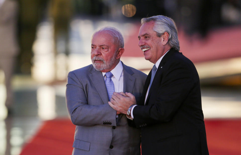 Brazilian President Luiz Inacio Lula da Silva, left, and Argentine President Alberto Fernandez pose for photos at the Alvorada palace in Brasilia, Brazil, Tuesday, May 2, 2023. (AP Photo/Gustavo Moreno)