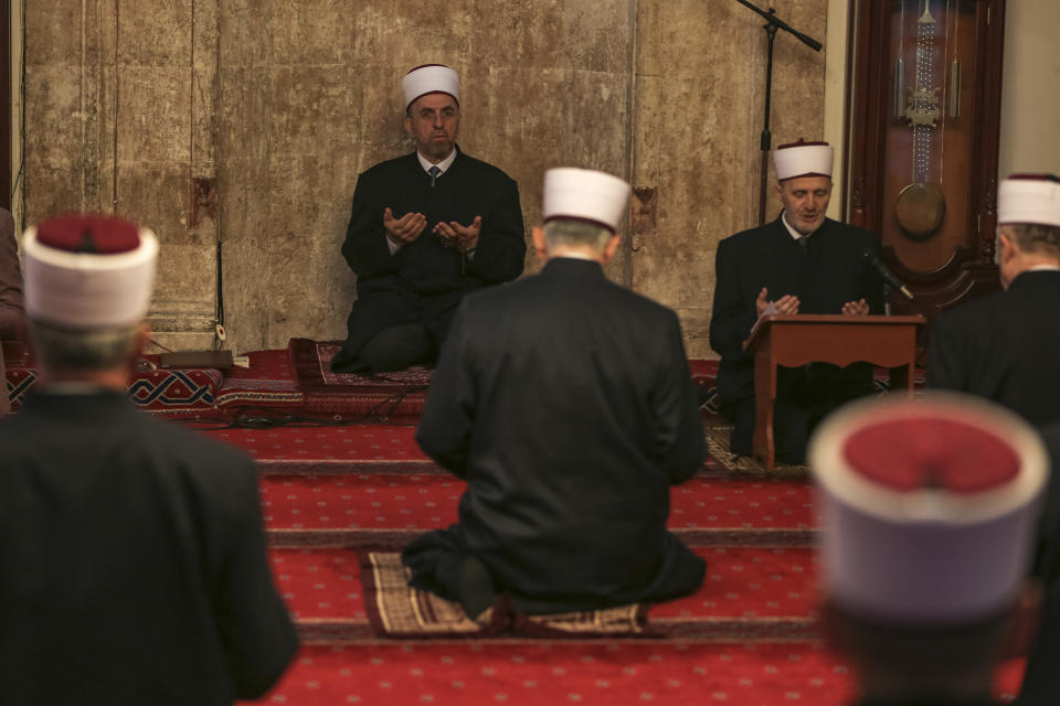 Kosovo's grand mufti Naim Ternava, left rear, leads the Eid al Fitr prayer at the grand mosque in Pristina, Kosovo on Sunday, May 24, 2020. Kosovo's mosques have been closed since March 14 because of the spread of the COVID-19 disease and despite the celebrations of the muslim holy month of Ramadan. (AP Photo/Visar Kryeziu)