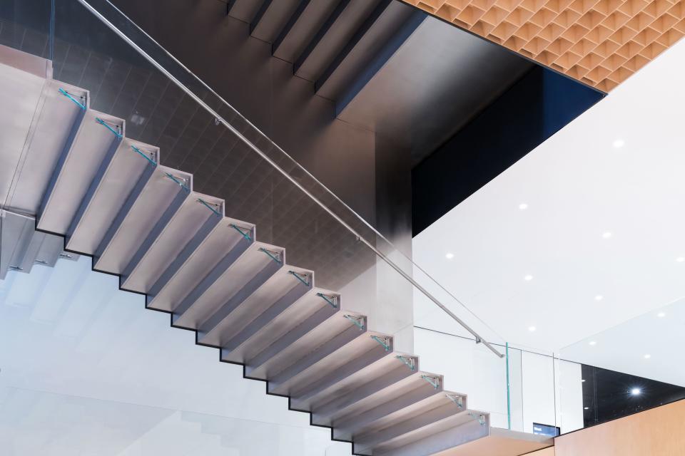 Supported by a six-inch-thin steel spine and distinguished by glass balustrades, MoMA’s new stair connects six floors of additional gallery spaces.