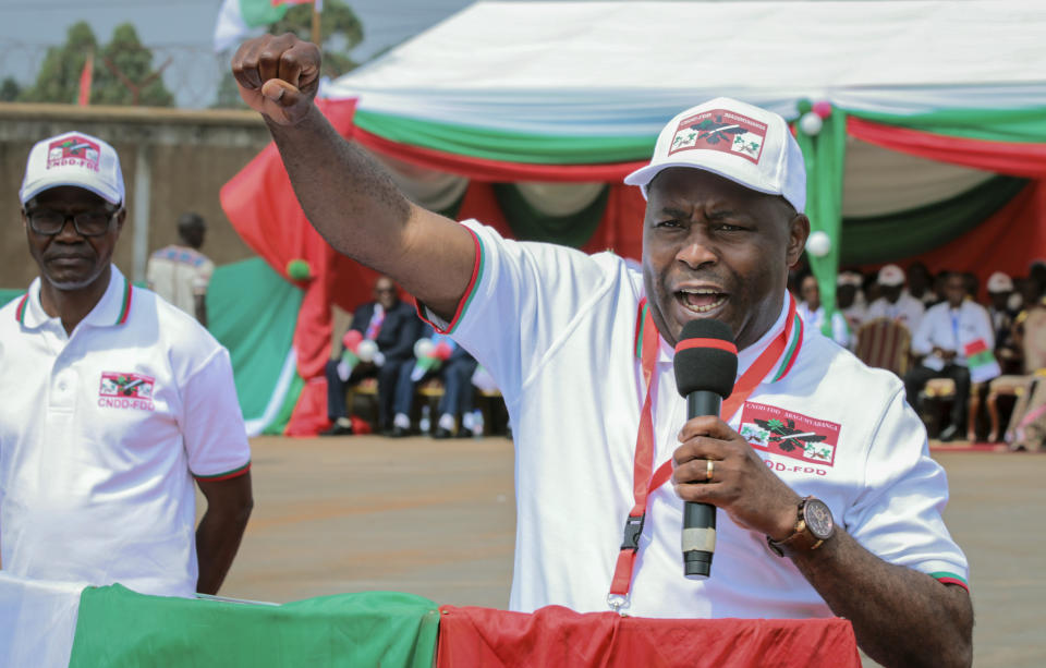 Burundi Army Gen. Evariste Ndayishimiye gestures to party supporters after being chosen as their presidential candidate, at a national conference for the ruling CNDD-FDD party in the rural province of Gitega, Burundi Sunday, Jan. 26, 2020. Burundi's ruling party chose Gen. Evariste Ndayishimiye to be its candidate in the presidential election set for May, signaling that the country's current president Pierre Nkurunziza will now retire after serving three terms. (AP Photo/Berthier Mugiraneza)