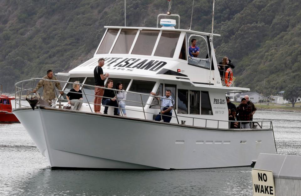 A boat carrying families of victims of the White Island eruption arrive back to the Whakatane wharf following a blessing at sea (AP)