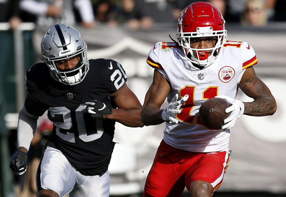 Kansas City Chiefs wide receiver Demarcus Robinson (11) runs in front of Oakland Raiders cornerback Daryl Worley (20) during the first half of an NFL football game in Oakland, Calif., Sunday, Dec. 2, 2018. (AP Photo/D. Ross Cameron)