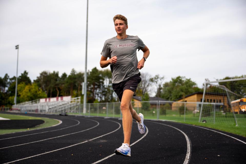 Holland Christian's Parker Lambers runs down the track before his cross country practice Thursday, Oct. 13, 2021, at Holland Christian High School. 