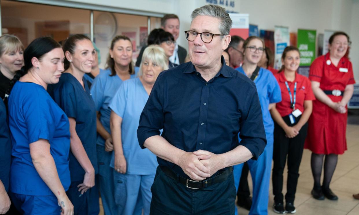 <span>Labour party leader Keir Starmer meets staff at Bassetlaw hospital in Nottinghamshire on Saturday. </span><span>Photograph: Stefan Rousseau/PA Wire</span>