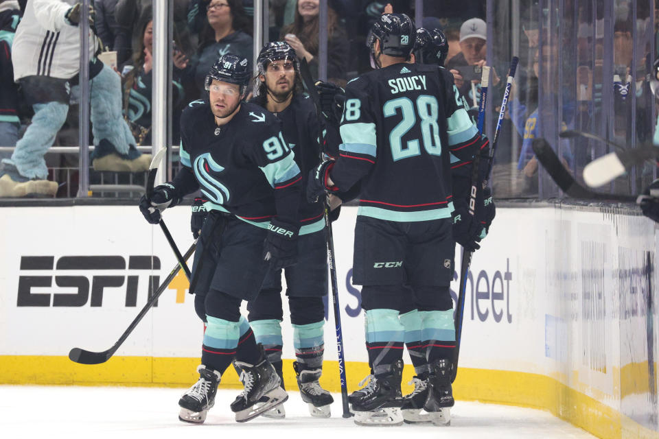 Seattle Kraken right wing Daniel Sprong, left, celebrates with teammates after scoring a goal during the second period of an NHL hockey game against the Anaheim Ducks Tuesday, March 7, 2023, in Seattle. (AP Photo/Jason Redmond)