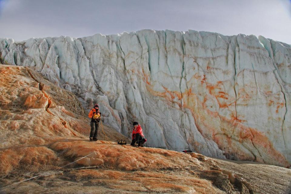 Glaciologists collecting data near the glacier