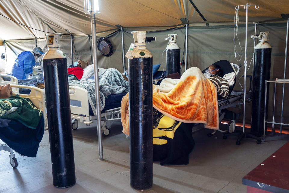 FILE - In this July 10, 2020, file photo, COVID-19 patients are treated with oxygen at the Tshwane District Hospital in Pretoria, South Africa. Africa’s confirmed coronavirus cases have surpassed 1 million, but global health experts tell The Associated Press the true toll is several times higher. (AP Photo/Jerome Delay, File)