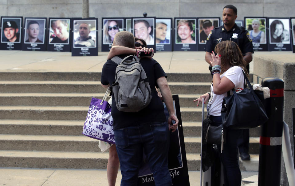 Protesters gather outside a courthouse on Friday, Aug. 2, 2019, in Boston, where a judge was to hear arguments in Massachusetts' lawsuit against Purdue Pharma over its role in the national drug epidemic. Organizers said they wanted to continue to put pressure on the Connecticut pharmaceutical company and the Sackler family that owns it. (AP Photo/Charles Krupa)
