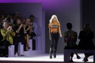 FILE - In this Friday, Sept. 21, 2018 file photo, Donatella Versace comes on the catwalk at the end of Versace's women's 2019 Spring-Summer collection, unveiled during the Fashion Week in Milan, Italy. An Italian newspaper report says that the Versace group is on the verge of announcing its sale to an American company. Corriere della Sera reported Monday, Sept. 24, 2018 that the possible buyers include Michael Kors and Tiffany, and that the deal would value the Italian fashion group founded by the late Gianni Versace for 2 billion euros. (AP Photo/Antonio Calanni), File