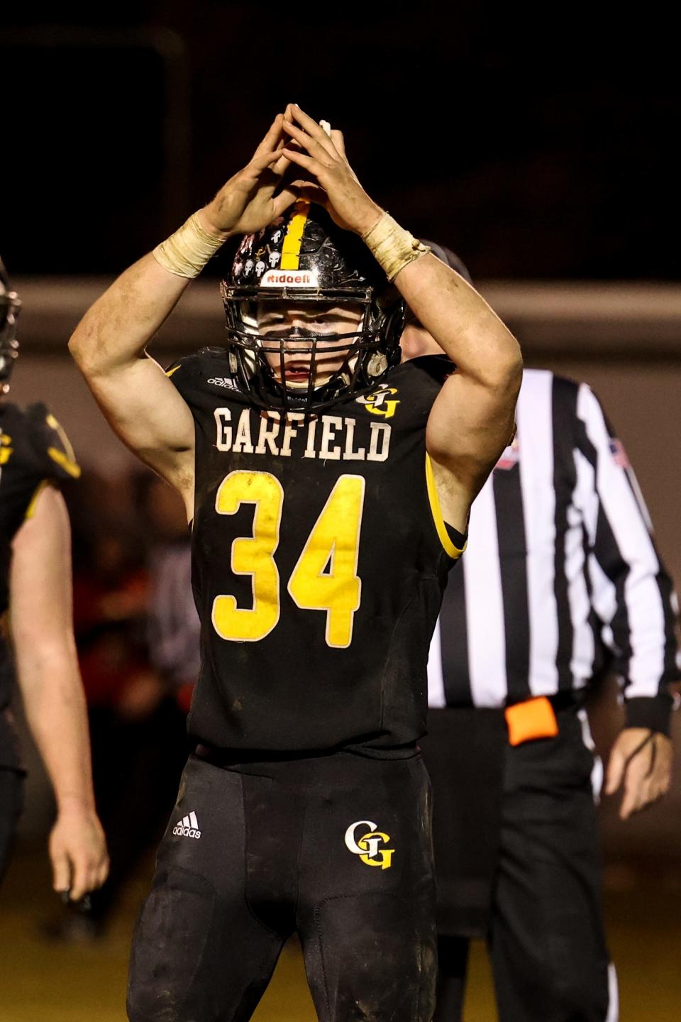 Garfield linebacker Keegan Sell signals safety after a big defensive play by Garfield’s Anthony Demma would lead to an intentional grounding call against Bellaire. 
