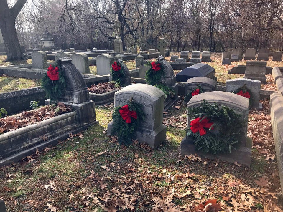 In this undated photo, provided by Amy Lambert, the Haseltine family plot at The Woodland Cemetery in Philadelphia is decorated ahead of the winter holiday season. Lambert is part of the cemetery's volunteer group, called Grave Gardeners, and said the Haseltine name has gone away but family descendants decorate this plot every November. (Amy Lambert via AP)