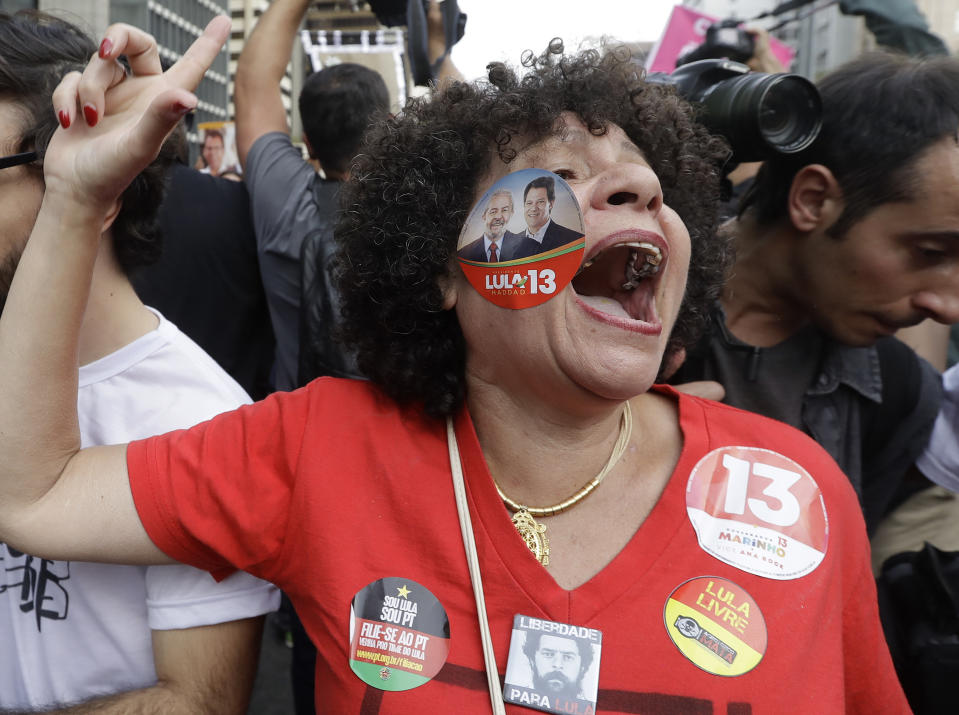 A woman shouts slogans in support of Fernando Haddad, presidential candidate for the Workers Party, during a campaign rally in Sao Paulo, Brazil, Sunday, Sept. 16, 2018. Brazil will hold general elections on Oct. 7. (AP Photo/Andre Penner)