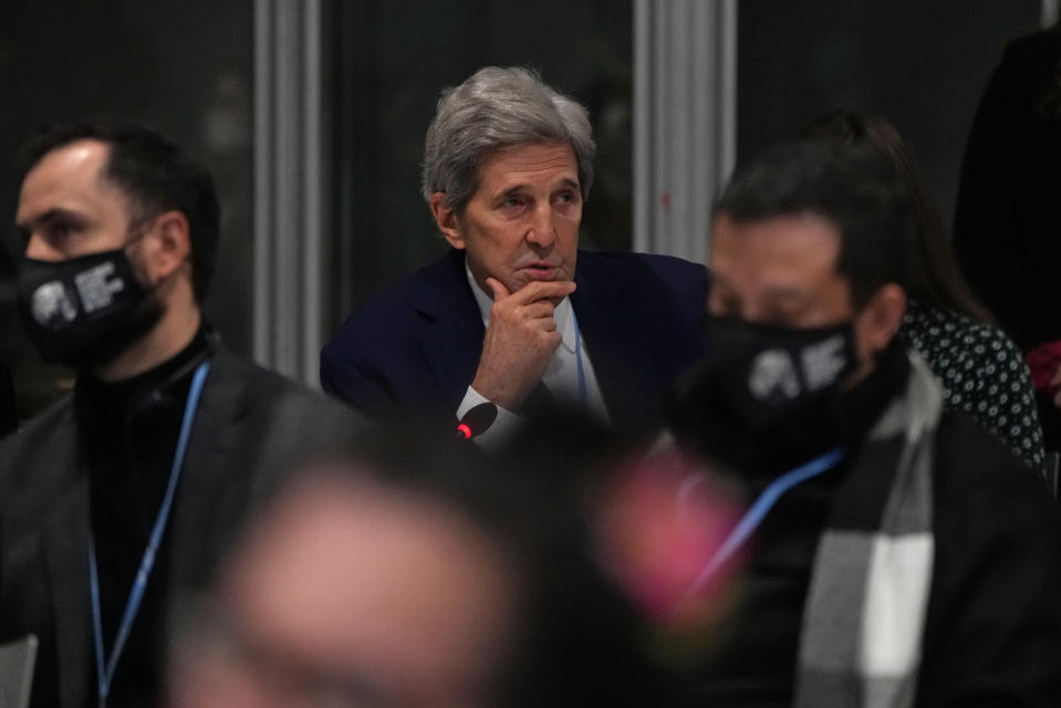 John Kerry, United States Special Presidential Envoy for Climate, center, pauses during a stocktaking plenary session at the COP26 U.N. Climate Summit in Glasgow, Scotland, Saturday, Nov. 13, 2021. Going into overtime, negotiators at U.N. climate talks in Glasgow are still trying to find common ground on phasing out coal, when nations need to update their emission-cutting pledges and, especially, on money. (AP Photo/Alastair Grant)