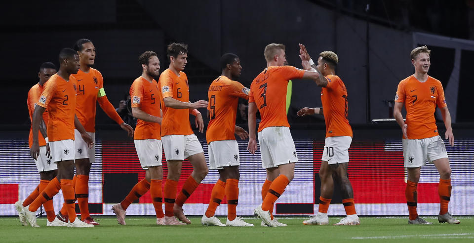 Netherland's team celebrates the opening goal by Virgil Van Dijk, 3rd from left, during the UEFA Nations League soccer match between The Netherlands and Germany at the Johan Cruyff ArenA in Amsterdam, Saturday, Oct. 13, 2018. (AP Photo/Peter Dejong)