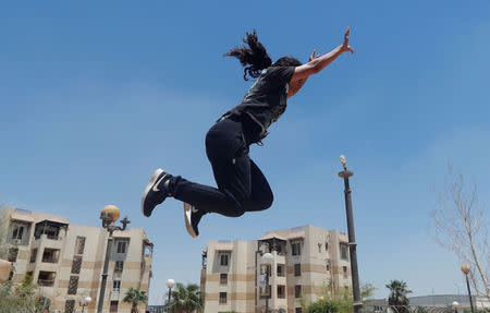 Mariam Emad from Parkour Egypt "PKE" practices her parkour skills around buildings on the outskirts of Cairo, Egypt July 20, 2018. REUTERS/Amr Abdallah Dalsh