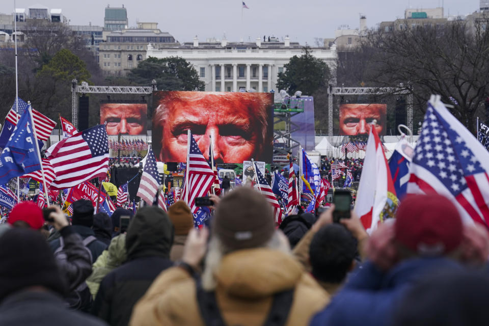 FILE - The face of President Donald Trump appears on large screens as supporters participate in a rally in Washington, Jan. 6, 2021. Members of the House committee investigating the events of Jan. 6 will hold their first prime time hearing Thursday, June 9, 2022, to share what they have uncovered. (AP Photo/John Minchillo, File)