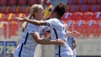 Portland Thorns FC forward Simone Charley, right, receives a hug from teammate Portland Thorns FC midfielder Lindsey Horan, left, after scoring against the North Carolina Courage during the second half of an NWSL Challenge Cup soccer match at Zions Bank Stadium Saturday, June 27, 2020, in Herriman, Utah. (AP Photo/Rick Bowmer)