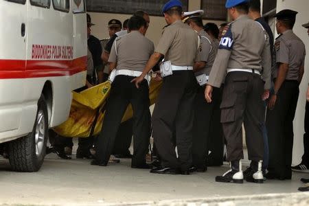 Police carry body bags, one of which is believed to contain the remains of Santoso, the country's most-wanted militant, killed in a clash with security forces, from an ambulance at a hospital in Palu, Central Sulawesi, Indonesia July 19, 2016 in this photo taken by Antara Foto. Antara Foto/Zainuddin MN/via REUTERS