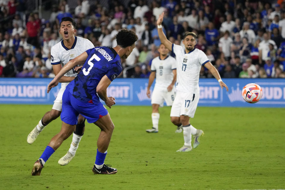 United States defender Antonee Robinson (5) collides with El Salvador forward Kevin Reyes, left, while trying to get to the ball during the first half of a CONCACAF Nations League soccer match Monday, March 27, 2023, in Orlando, Fla. (AP Photo/John Raoux)