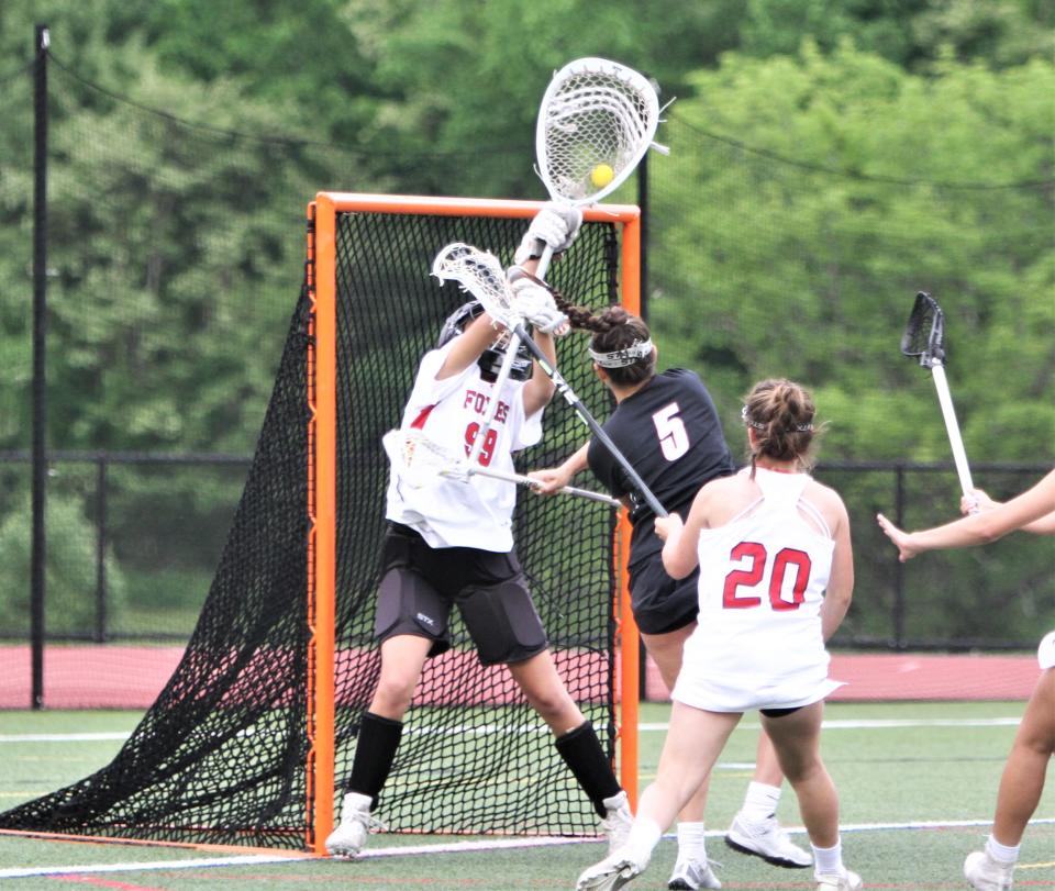 Mamaroneck's Shawn Rosenblatt (5) is stopped by Fox keeper Sophia Kothari during Mamaroneck's 10-8 Section 1 Class A semifinal win May 23, 2022 at Fox Lane. But Rosenblatt shared top game honors with three goals and three assists.