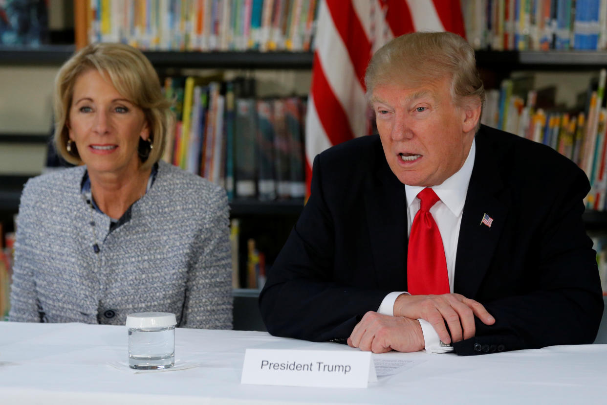 U.S. President Donald Trump (R) and Education Secretary Betsy DeVos (L) meet with parents and teachers at Saint Andrew Catholic School in Orlando, Florida, U.S. March 3, 2017. REUTERS/Jonathan Ernst