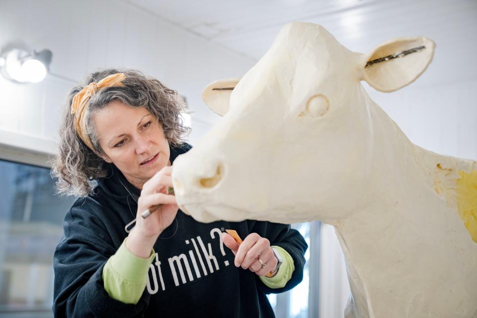 Sarah Pratt works on the butter cow in the Agriculture building at the Iowa State Fairgrounds, Tuesday, Aug. 8, 2023.