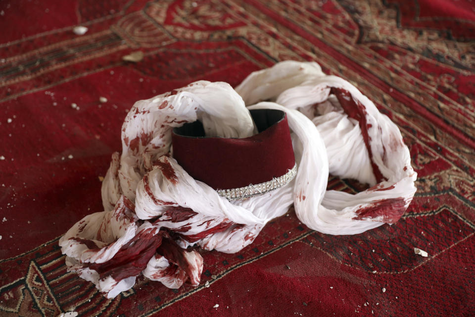 A blood-stained turban and cap are seen inside a mosque after a bomb explosion in Shakar Dara district of Kabul, Afghanistan, Friday, May 14, 2021. A bomb ripped through a mosque in northern Kabul during Friday prayers killing 12 worshippers, Afghan police said. (AP Photo/Rahmat Gul)