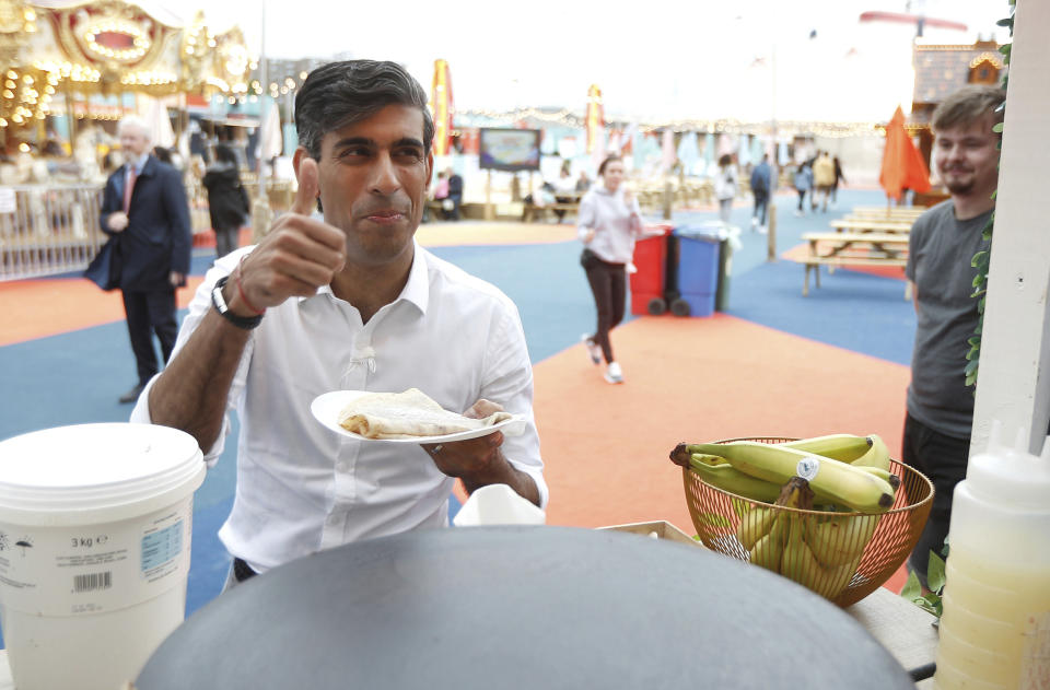 FILE - Britain's Chancellor of the Exchequer Rishi Sunak gestures, during a visit to London Wonderground festival, as he announces further support for the events sector, in London, Thursday, Aug. 5, 2021. (Peter Nicholls/Pool Photo via AP, File)