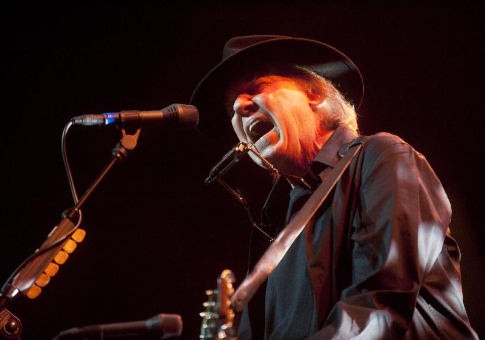 FILE - In this May 14, 2012 file photo originally provided by Robin Hood, musician Neil Young performs onstage at the Robin Hood Annual Benefit, Monday, May 14, 2012, at the Javits Center in New York. Young, whose memoir "Waging Heavy Peace" due out in October, will be interviewed by fellow singer Patti Smith at BookExpo America in New York this week. (AP Photo/Courtesy Robin Hood, file)