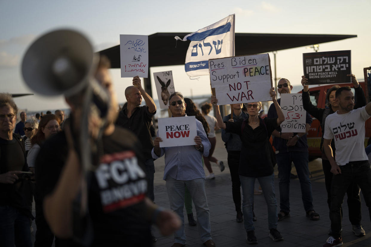 People demonstrate demanding a regional peace agreement outside of the U.S. Embassy Branch Office in Tel Aviv. (Leo Correa / AP)