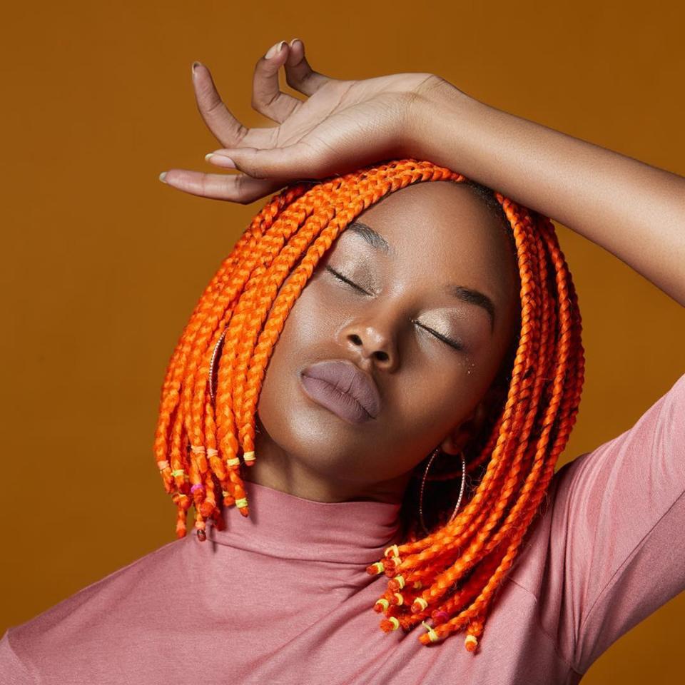 Pumpkins ain't got nothing on this adorable orange bob. We love these bright box braids on <a href="https://www.instagram.com/lxndxox/" rel="nofollow noopener" target="_blank" data-ylk="slk:Lindiwe Dim;elm:context_link;itc:0;sec:content-canvas" class="link ">Lindiwe Dim</a>, snipped short and secured with yellow, peach, and pink elastics.