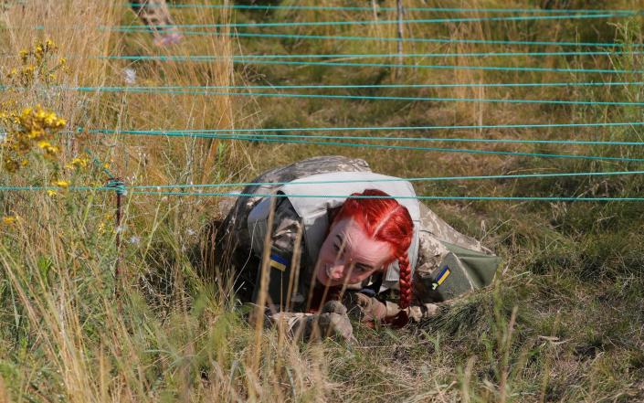 Ukrainian women attend the testing of a new women's military uniform during military training at a shooting range near Kyiv, Ukraine