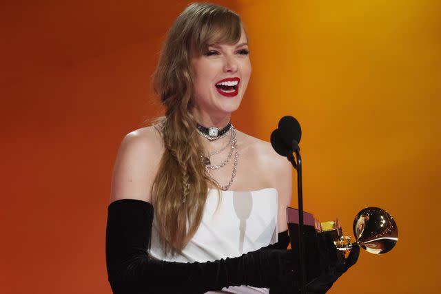 <p>Kevin Mazur/Getty</p> Taylor Swift accepts the Best Pop Vocal Album award at 2024 Grammys
