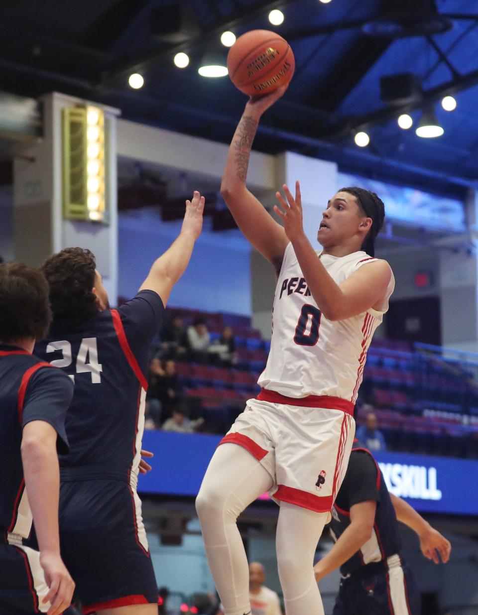 PeekskillÕs Jaden Chavis (0) puts up a shot against Eastchester during the Section1 Class AA boys basketball semifinal at the Westchester County Center in White Plains Feb. 27, 2024.