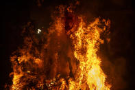 <p>A man rides a horse through a bonfire as part of a ritual in honor of Saint Anthony, the patron saint of domestic animals, in San Bartolome de Pinares, west of Madrid, Jan. 16, 2017. (Photo: Daniel Ochoa de Olza/AP) </p>