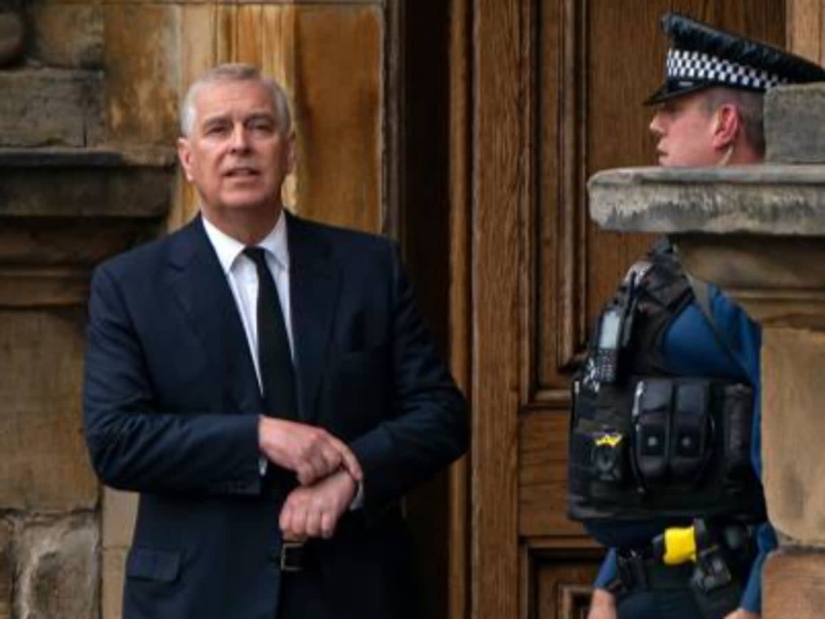 A police officer stands alongside Britain's Prince Andrew, Duke of York as they await the arrival of the coffin of Queen Elizabeth II (AFP/Getty)