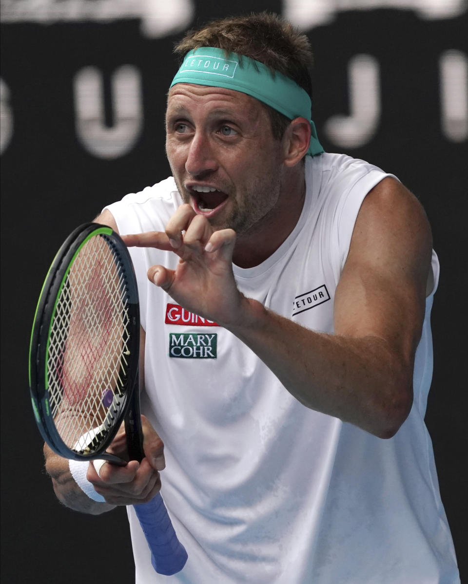 Tennys Sandgren of the U.S. reacts after losing a point to Switzerland's Roger Federer during their quarterfinal match at the Australian Open tennis championship in Melbourne, Australia, Tuesday, Jan. 28, 2020. (AP Photo/Lee Jin-man)