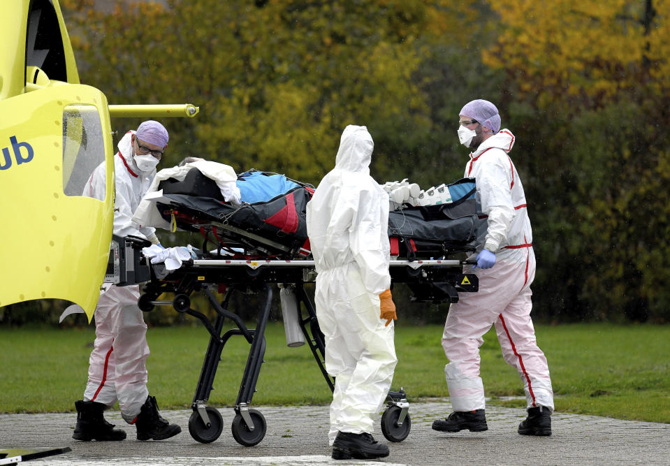 A corona patient from the Netherlands is transferred from a helicopter to the University Hospital in Muenster, Germany, Friday, Oct. 23, 2020. The transfer is intended to reduce the pressure on the intensive care units in the Netherlands. l at the University Hospital in Muenster, Germany, Friday, Oct. 23, 2020. The transfer is intended to reduce the pressure on the intensive care units in the Netherlands. (Caroline Seidel/dpa via AP)