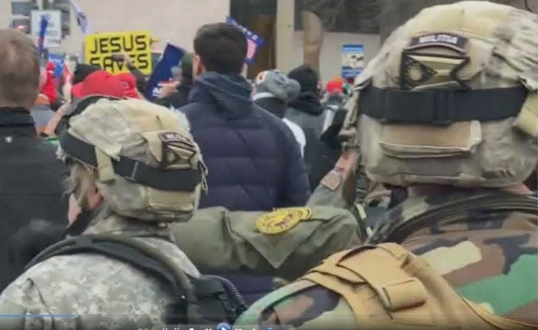 Two people outside the Capitol Building Jan. 6 wore helmets with the Ohio state flag and "MILITIA" patches. Court documents identify them as Sandra and Bennie Parker.