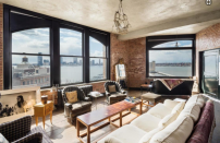 <p>The large arched windows offer lots of natural light, and views of the city skyline. Source: Streeteasy via Douglas Elliman </p>