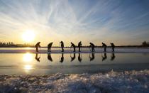 <p>Workers use sawsto dig big ice blocks from the frozen Songhua River in Harbin. The ice blocks are then transported to thefestivalareas.</p>