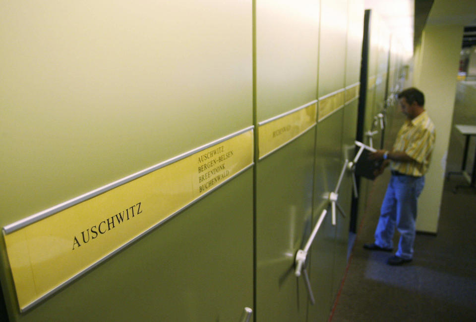 An employee of the International Tracing Service (ITS), an arm of the International Committee of the Red Cross and based in Bad Arolsen, works in a part of the ITS files department 28 July 2006.  (MARTIN OESER/AFP/Getty Images)