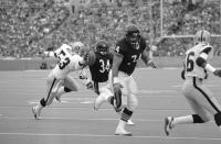 FILE - In this Nov. 4, 1984, file photo, Chicago Bears running back Walter Payton, (34), eludes Los Angeles Raiders linebacker Rod Martin (53) as he follows blocking of Bears tackle Jim Covert (74) to score his second touchdown in the first half of an NFL football game at Soldier Field in Chicago. Covert made the people he played alongside look good, and after a nearly two-decades-long wait, the tough Chicago Bears left tackle will join them in the Pro Football Hall of Fame. (AP Photo/Steve Green, File)