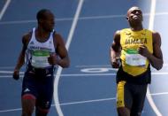 2016 Rio Olympics - Athletics - Preliminary - Men's 100m Round 1 - Olympic Stadium - Rio de Janeiro, Brazil - 13/08/2016. James Dasaolu (GBR) of Britain and Usain Bolt (JAM) of Jamaica compete REUTERS/David Gray