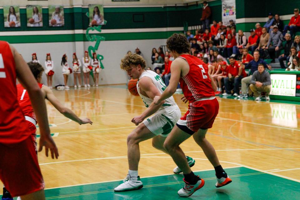 Wall boys basketball's Logan Thomas (33) posts up Jim Ned's Carter Lange (22) in a matchup at Wall High School on Jan. 16, 2024.