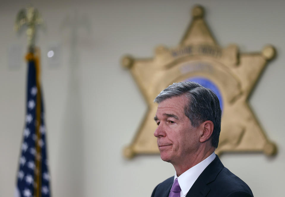 North Carolina Gov. Roy Cooper listens during a press conference about the power outage in Moore County on Monday, Dec. 5, 2022, in Carthage, N.C. (Kaitlin McKeown/The News & Observer via AP)