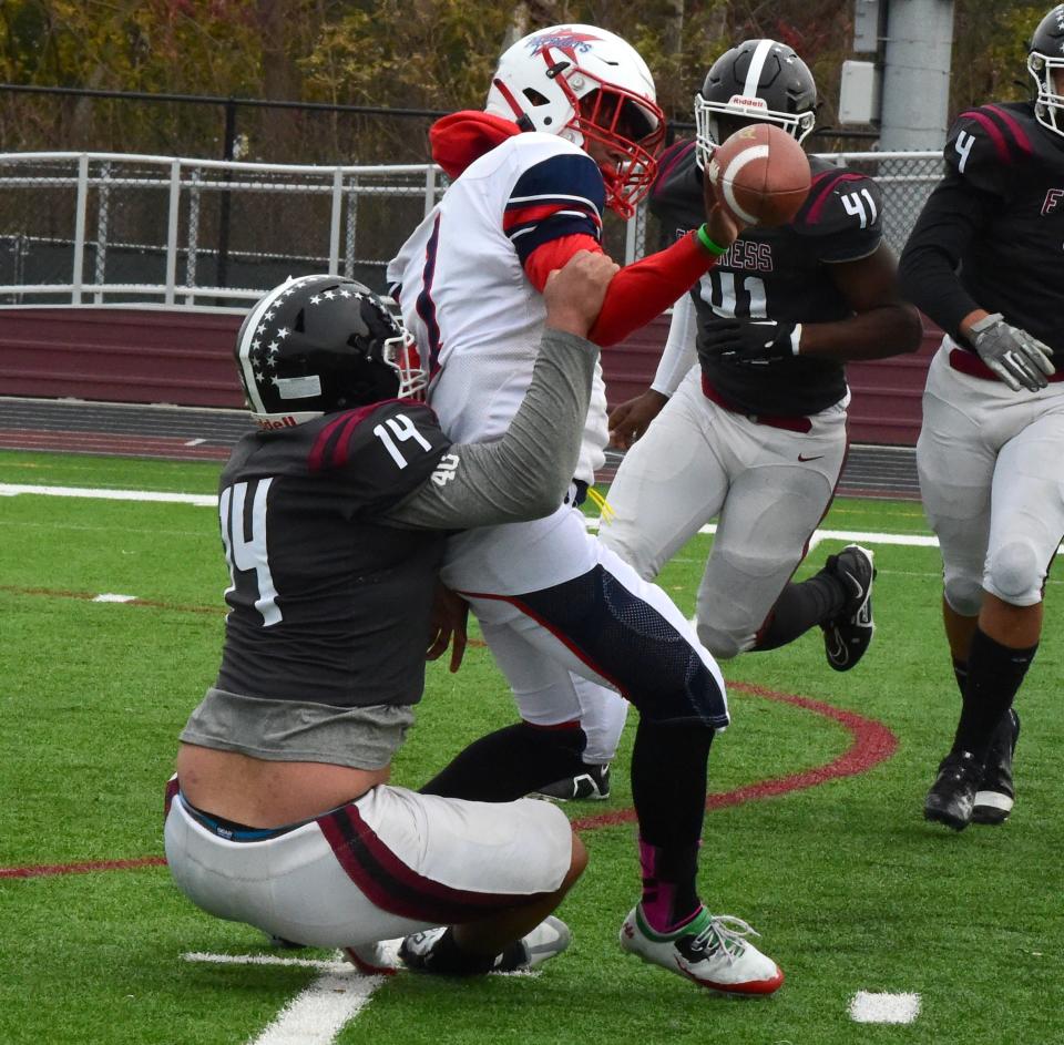 Elmira's Chris Woodard sacks Binghamton quarterback Kashif Summers and forces a fumble in the Express' 61-12 victory in a Section 4 Class AA football semifinal Nov. 4, 2023 at Elmira High School's Thomas J. Hurley Athletic Complex.
